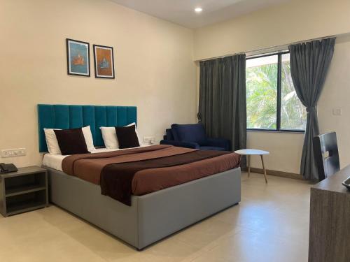 a bedroom with a large bed and a window at Girivihar Pure Veg Resort Lonavala - ગિરિવિહાર રિસોર્ટ , in Lonavala