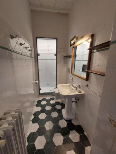 a bathroom with a sink and a toilet and a window at Castello di Mugnana in Mugnana