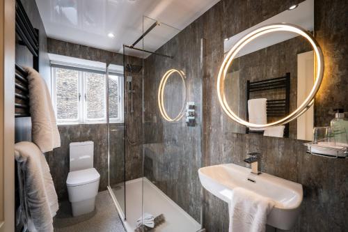 a bathroom with a sink and a mirror at Ambleside Townhouse in Ambleside