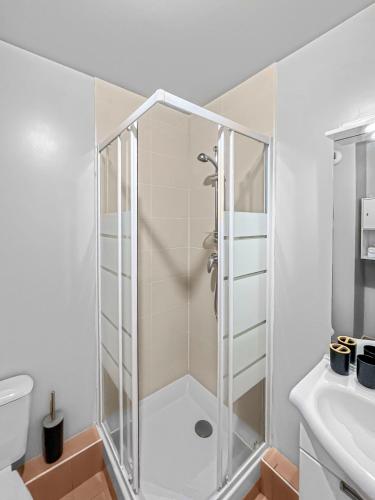 a shower with a glass door in a bathroom at Studio enchanté avec terrasse in Luce