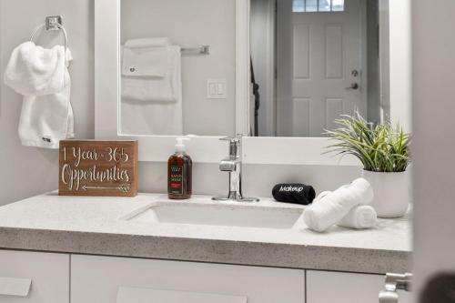 a bathroom counter with a sink and a mirror at Chicago Treasure 4 Bed Getaway in Chicago