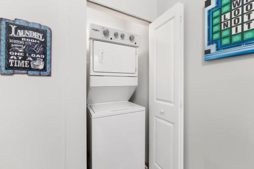 a white refrigerator in a room with a door at Chicago Treasure 4 Bed Getaway in Chicago