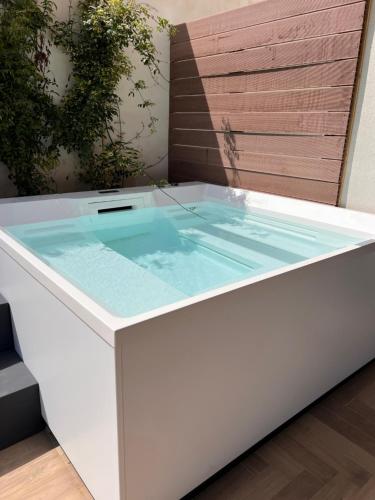 a bathtub with a pool of water in it at SHAH Rooms&relax in Taranto