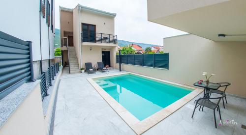 a swimming pool in the backyard of a house at Apartments Gallery M and A - with pool in Mostar
