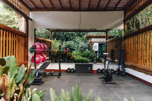 a gym with exercise equipment on a patio at Pousada Alto da Pipa in Pipa