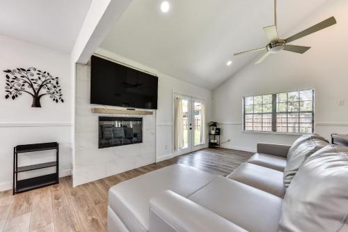 a living room with a white couch and a fireplace at Walk to Trout River Pier Modern Home with Yard in Jacksonville