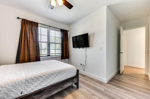 a bedroom with a bed and a flat screen tv at Walk to Trout River Pier Modern Home with Yard in Jacksonville