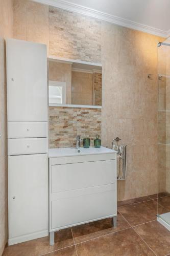 a bathroom with a white sink and a mirror at Seaflower Torrox Costa in Torrox Costa