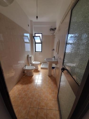 a bathroom with two sinks and two toilets at Elezi House in Durrës