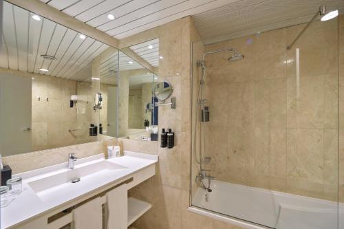 a bathroom with a sink and a shower and a tub at Eurostars Don Cándido in Terrassa
