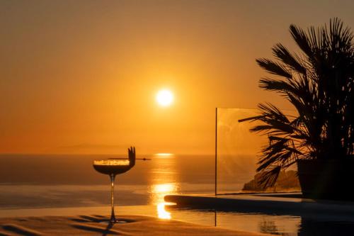 a view of the sun setting over the ocean at Nomia Sunset Suites Mykonos in Tagou