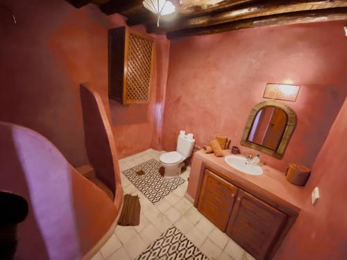 a bathroom with a sink and a toilet and a mirror at Riad Prada in Marrakech