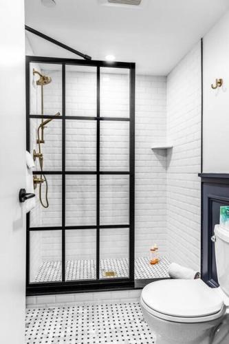 a bathroom with a shower and a toilet in it at Historic DTWN Bangor, Steps to great Food & Drink, Room # 102 in Bangor