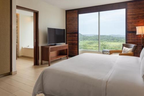 a bedroom with a large bed and a television at The Westin Playa Bonita Panama in Playa Bonita Village