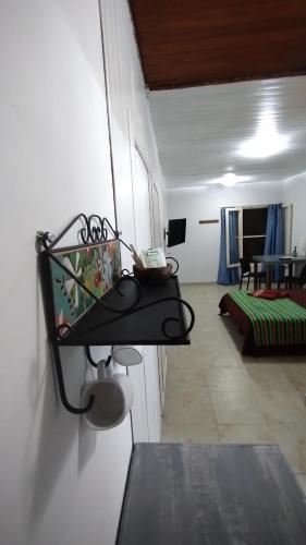 a room with a shelf on the wall at Aloha hospedaje in Puerto Iguazú