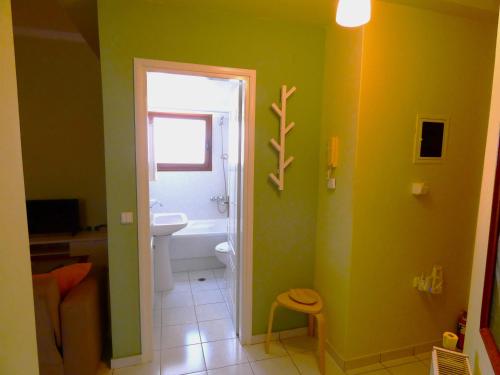 a bathroom with a white toilet and a sink at Mel Studio 2 (kalamaki) in Kalamaki