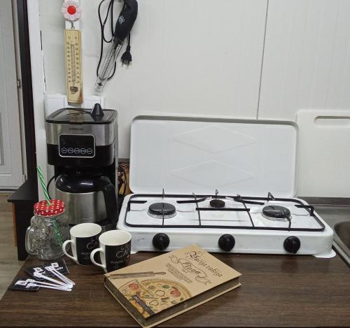a kitchen counter with a stove and a coffee maker at Krčma u Planini in Bojnik