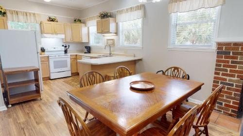 a kitchen and dining room with a wooden table and chairs at 10 13th Street by Tybee Vacation Rentals in Tybee Island