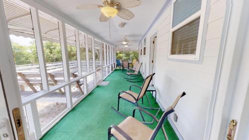 a corridor with chairs and tables and windows at 10 13th Street by Tybee Vacation Rentals in Tybee Island
