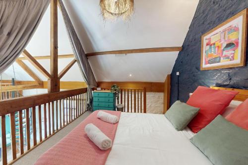 a bedroom with a bed and a balcony at Kiri Cottage Hawkridge in Dulverton