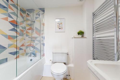 a bathroom with a toilet and a shower and a sink at Kiri Cottage Hawkridge in Dulverton