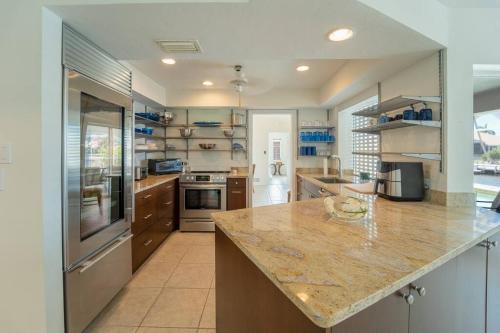 a large kitchen with a large counter top in it at ELEVATED 342 - Sunny Waterfront Pool and Spa 3 Bed home in Marco Island