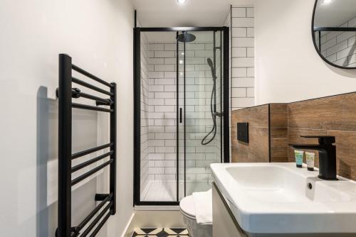 a bathroom with a sink and a shower at Lovely 1 Bedroom Apartment in Central Sheffield in Sheffield