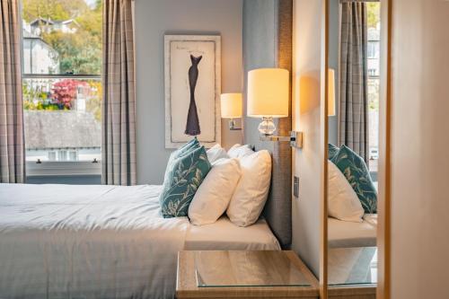 a hotel room with a bed and a window at Ambleside Townhouse in Ambleside