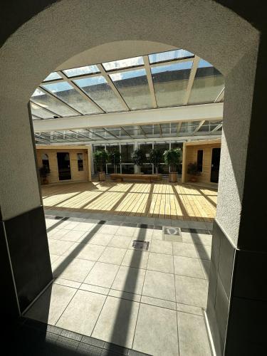 an openrium of a building with a large window at Landhotel Harz in Thale