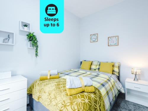 a bedroom with a bed with yellow sheets and yellow pillows at Stunning Spacious 2BR House in East Ardsley 