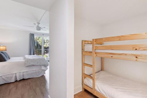 a bedroom with two bunk beds and a window at 1379 Shipwatch in Amelia Island