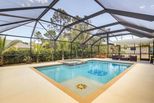 a swimming pool in a house with a glass ceiling at Near Parks Port St Lucie Home with Private Pool! in Port Saint Lucie