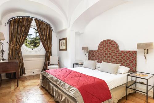 a bedroom with a large bed and a window at Villa Gallone in Sorrento