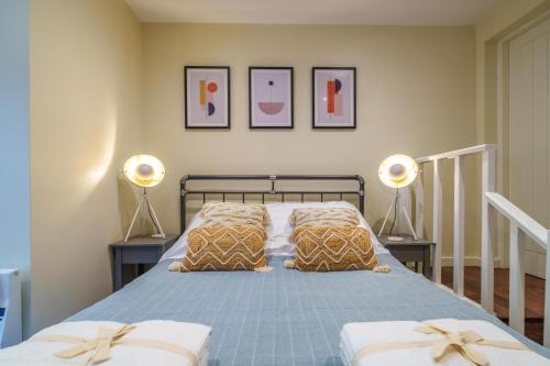 a bedroom with a bed with two pillows and two lamps at Weavers Two - Luxury Apartment for Two in Windermere