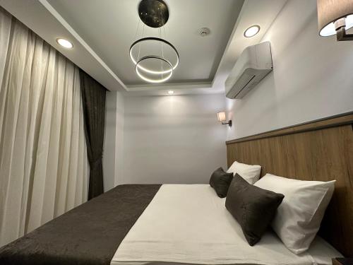 a bedroom with a bed and a tv on the ceiling at Quality Gold Suite Hotel in Antalya
