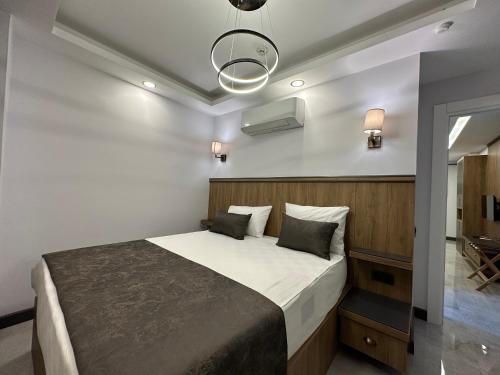 a bedroom with a large bed in a room at Quality Gold Suite Hotel in Antalya