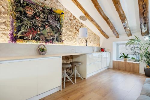 a kitchen with white cabinets and a brick wall at el Nido 14 in Hospitalet de l'Infant