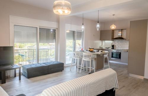 Una cocina y una sala de estar con un sofá y una mesa. en Nectar Beach House, en Neokhórion