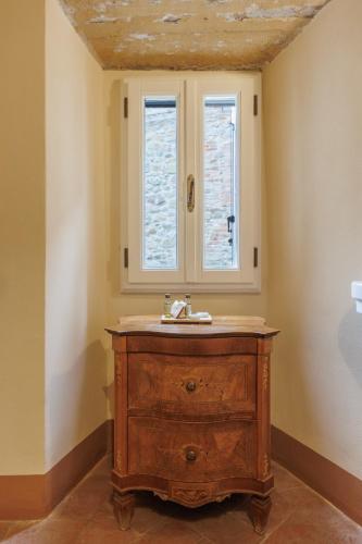 a bathroom with a wooden sink and a window at Hotel Villa Sermolli in Borgo a Buggiano