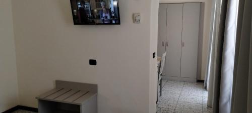 a room with a bench and a mirror on the wall at Hotel Elena in Recco