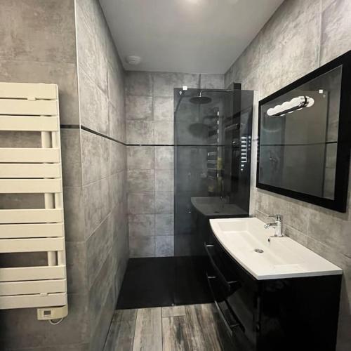 une salle de bain avec un lavabo et un miroir dans l'établissement Maison 3 chambres avec piscine chauffée, à Mios