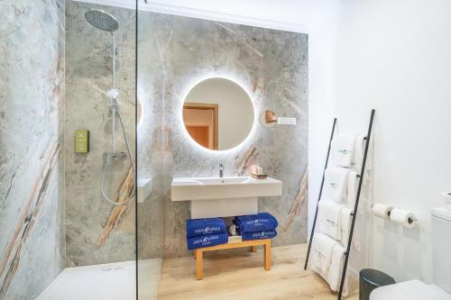 a bathroom with a sink and a mirror at Studios by Aqua Natura Hotels in Porto Moniz