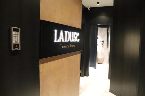 a sign for a luxury store with a bathroom at La Duse Luxury Rooms in Pescara