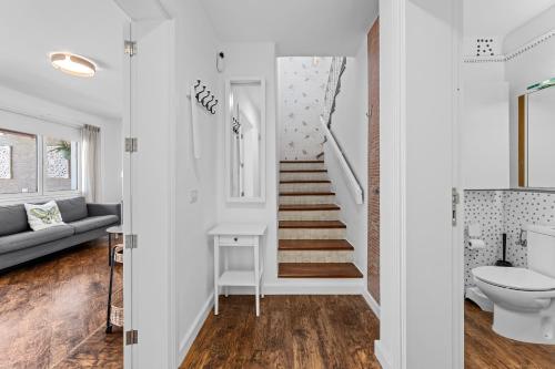 a white hallway with a staircase in a house at Casa Lily Lanzarote a 5 min del mar in Playa Honda