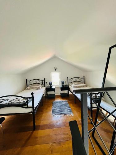 a room with two beds and a table at Studio Apartmani Sladakovic in Kistanje