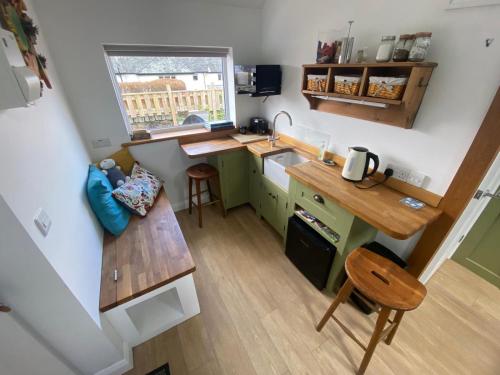 an overhead view of a small kitchen with a table at Claremont House Keswick in Keswick