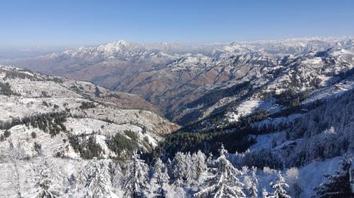 an aerial view of a snowy mountain range with trees at The Charvi Retreat Kufri Shimla by Exotic Stays I Family Accomodation I Valley & Mountain View I Kufri Shimla by Exotic Stays in Kūfrī