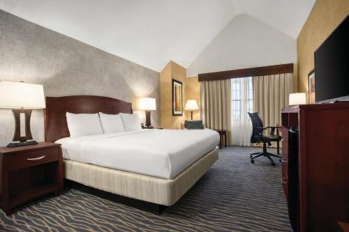 a hotel room with a bed and a television at Radisson Hotel Salt Lake City Airport in Salt Lake City