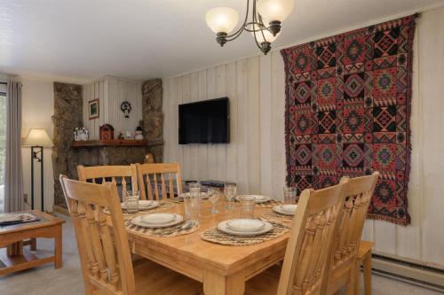 a dining room with a wooden table and chairs at Beaver Village Unit #0712R in Winter Park