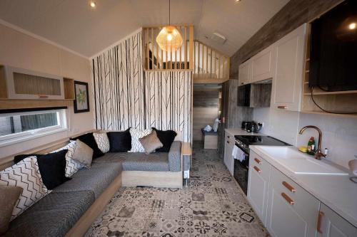 a living room with a couch in a kitchen at Self-Catering Lodge with Hot Tub in Inverness